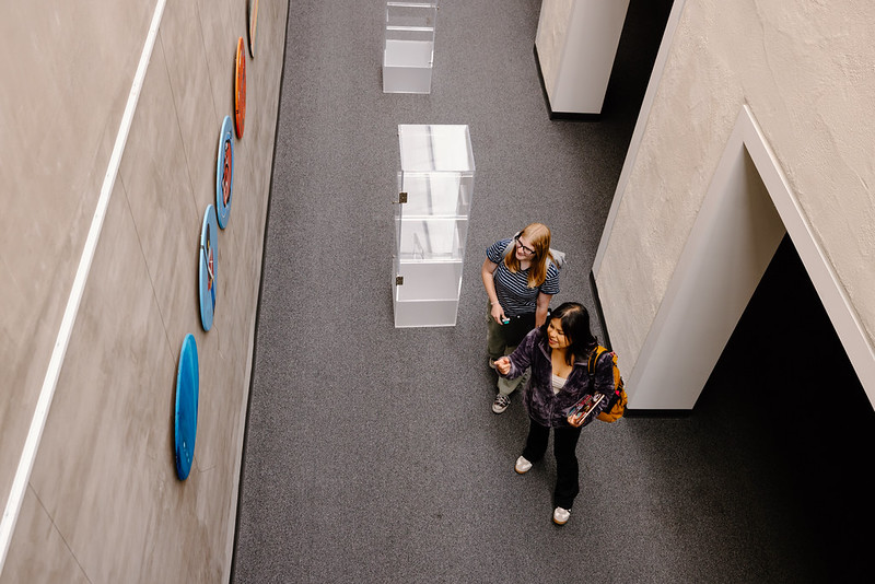 Students in Broome Library looking at artwork