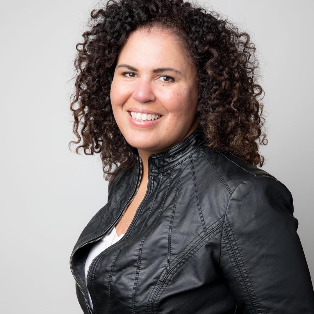 white background with photo of Safiya Noble in a black jacket