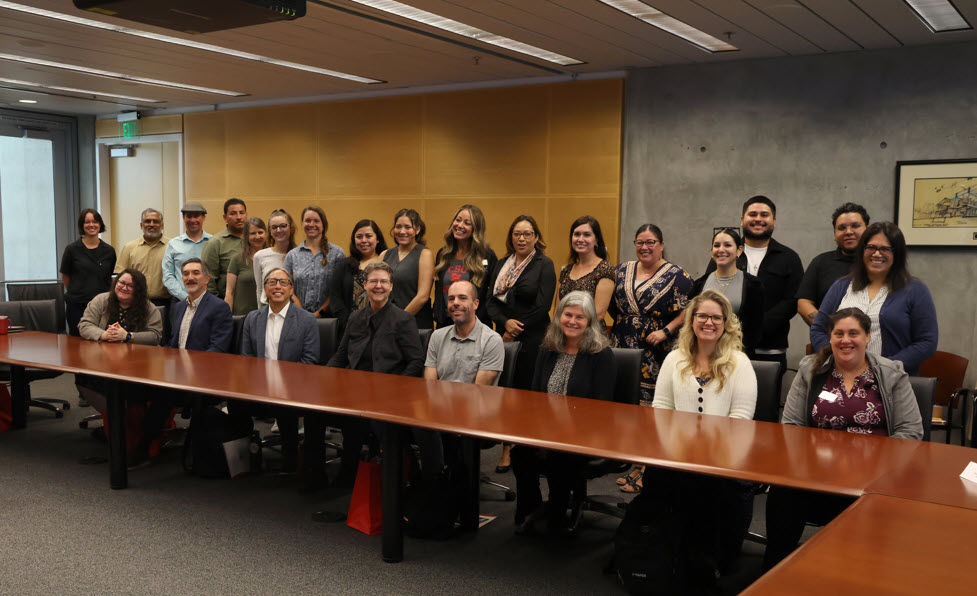 group photo of ci connect cohort 6 standing in a group behind a table smiling